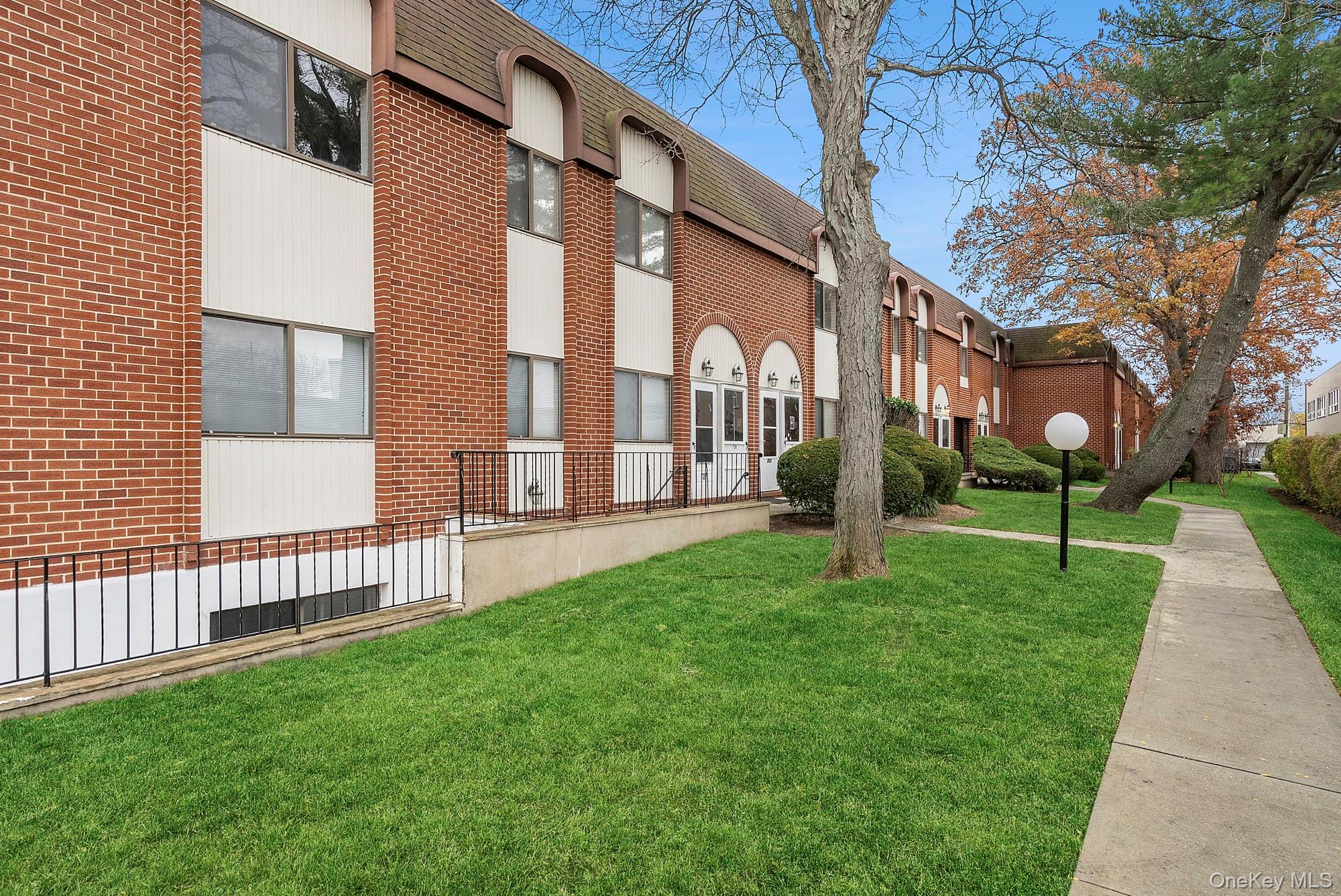 741 Chestnut Street, Unit 1 Cedarhurst, NY 11516 - Photo 1 of 1 a pathway of a house with a yard