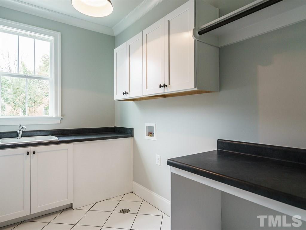 735 Mills Street Raleigh, NC 27608 - Photo 22 of 24 a kitchen with granite countertop white cabinets and a sink