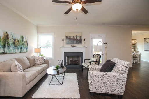 487 Norene Road Lebanon, TN 37090 - Photo 7 of 24 a living room with furniture a fireplace and a chandelier