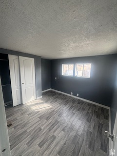 8155 South Redwood Road, Unit 96 West Jordan, UT 84088 - Photo 10 of 17 Unfurnished bedroom with a textured ceiling, wood finished floors, and a closet