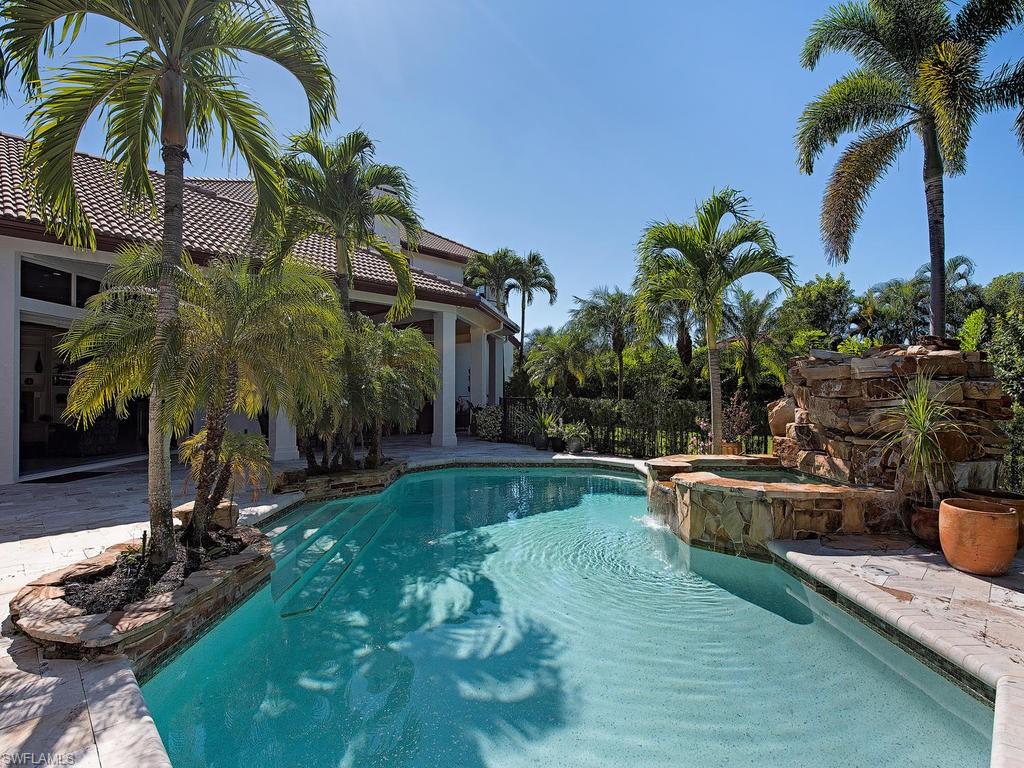 7347 Stonegate Drive Naples, FL 34109 - Photo 14 of 20 a view of a backyard with plants and swimming pool