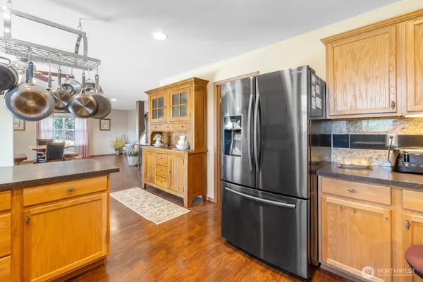 a kitchen with stainless steel appliances granite countertop a refrigerator and a stove top oven