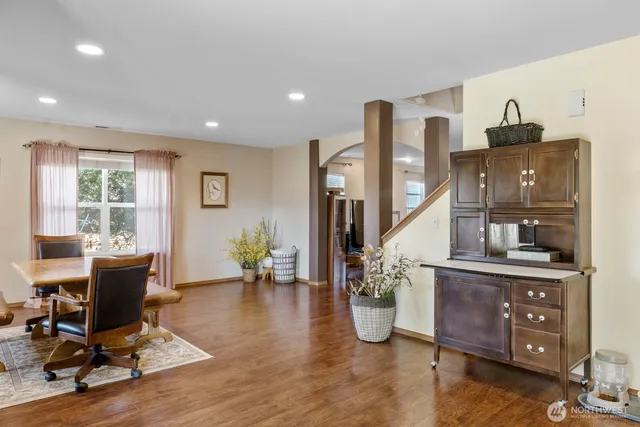 a view of a livingroom with furniture and a workspace