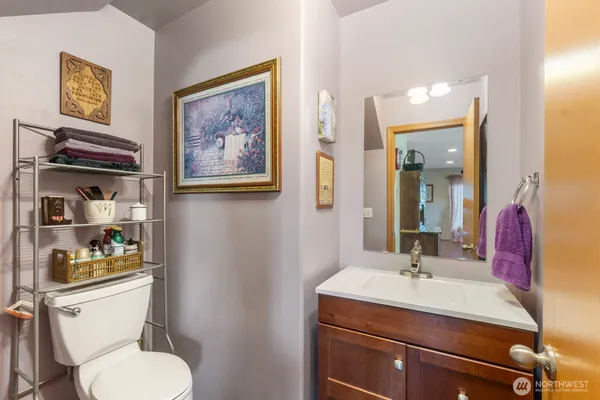 a bathroom with a toilet a sink and mirror
