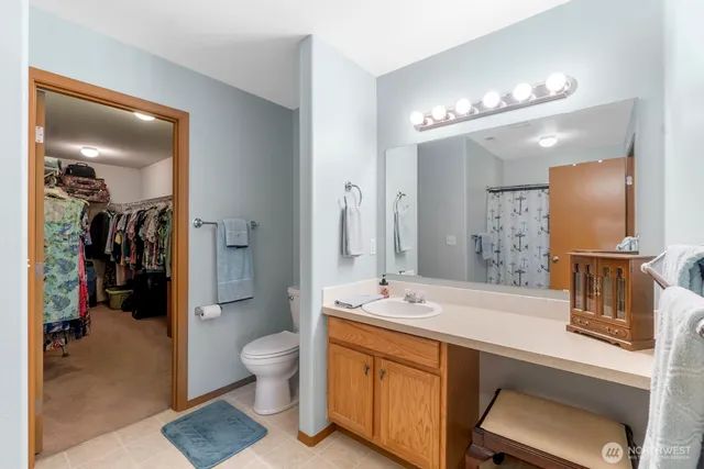 a spacious bathroom with a double vanity sink mirror and toilet
