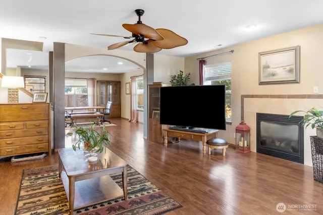 a living room with furniture wooden floor and a flat screen tv