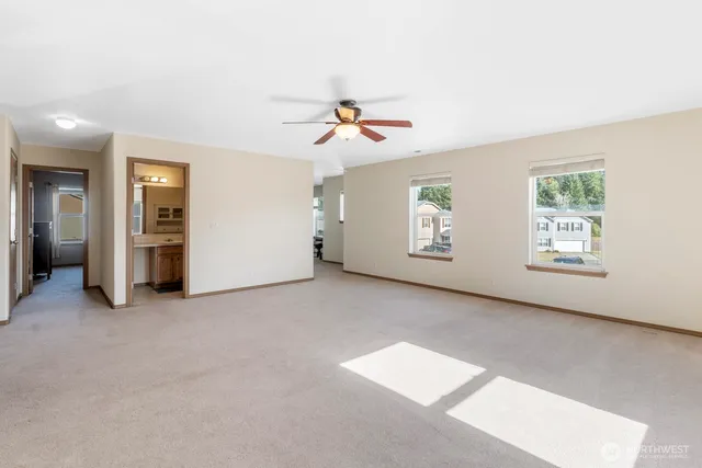 a view of a livingroom with a ceiling fan and window