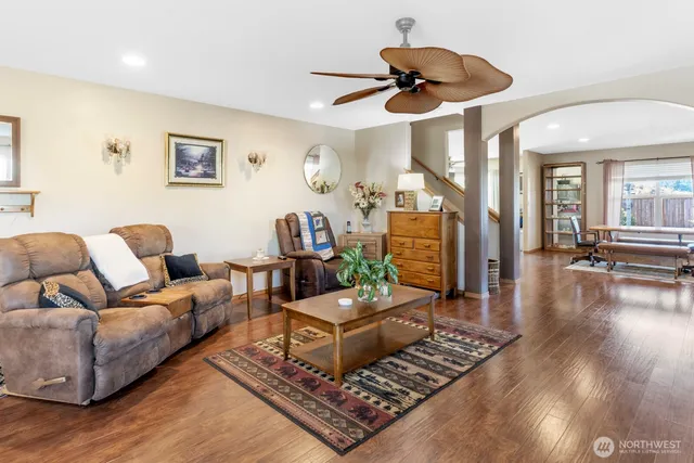 a living room with furniture and a wooden floor