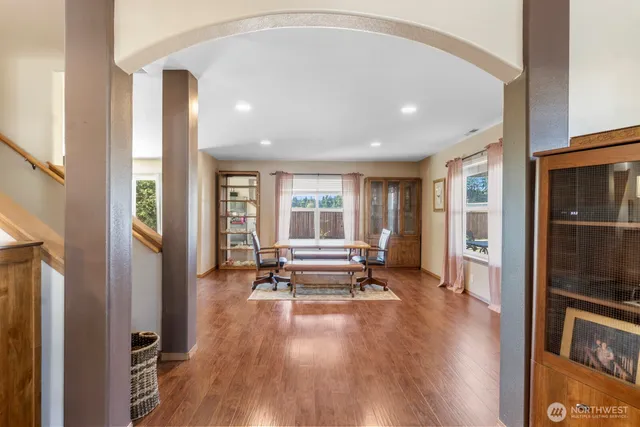 a view of workspace with wooden floor and windows