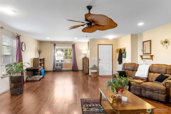 a living room with furniture and wooden floor