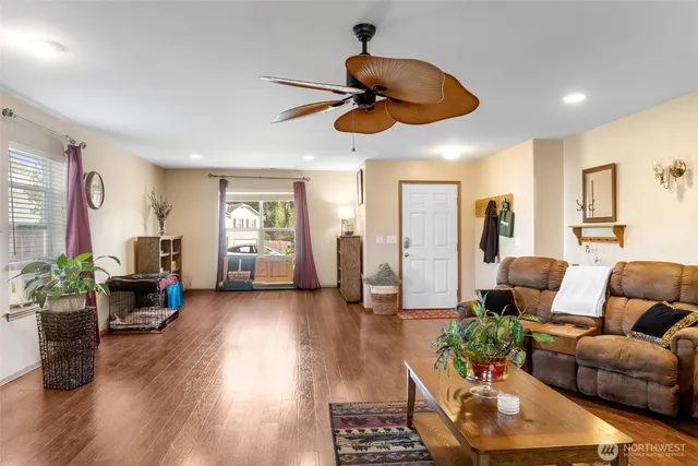 a living room with furniture and wooden floor