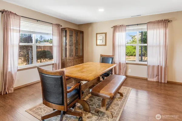 a dining room with furniture and wooden floor
