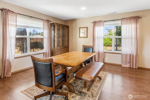 a dining room with furniture and wooden floor