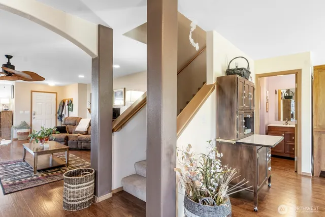a living room with furniture flowerpot and wooden floor