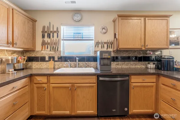 a kitchen with stainless steel appliances granite countertop a sink and cabinets