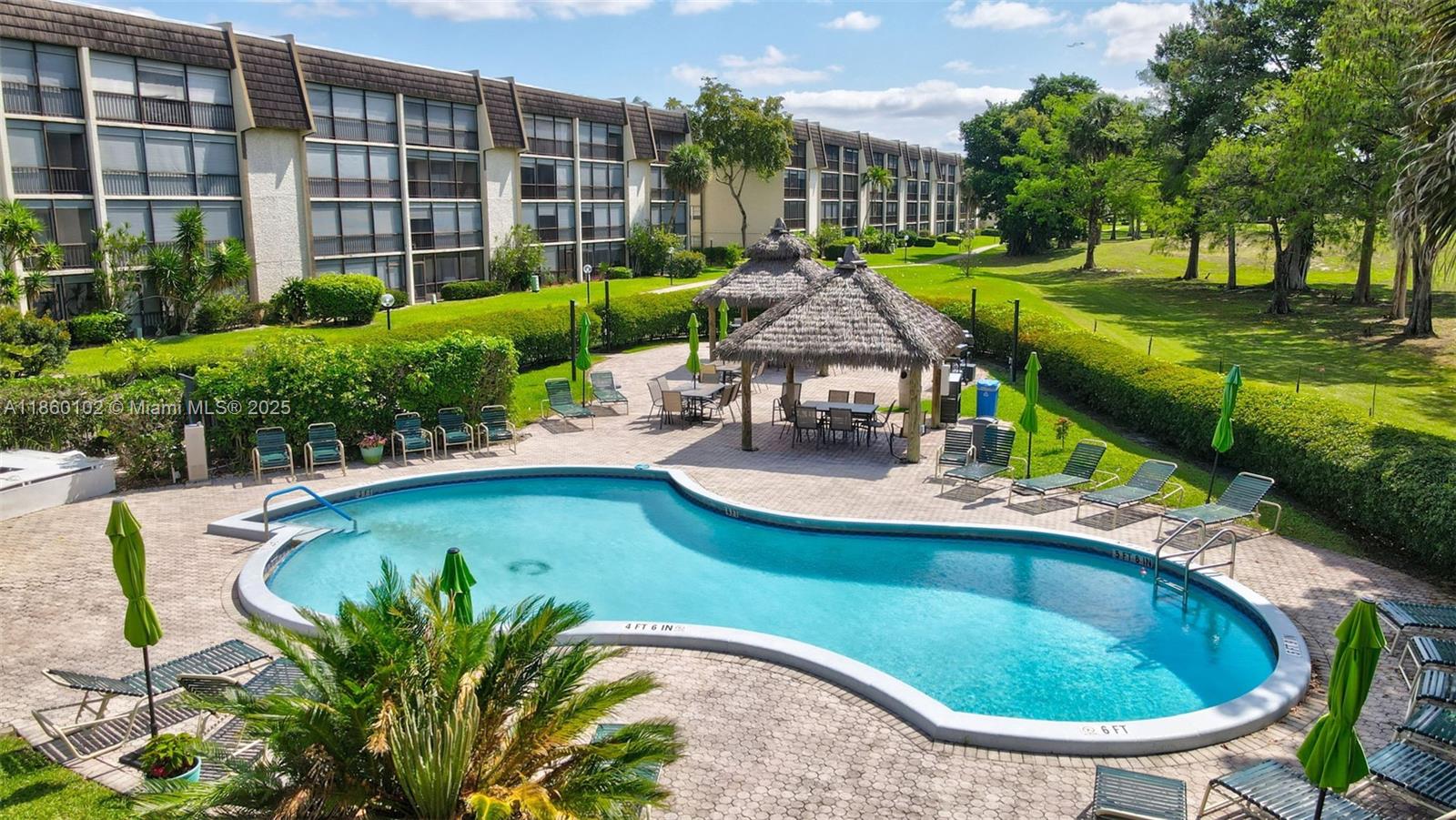 6020 Northwest 44th Street, Unit 401 Lauderhill, FL 33319 - Photo 11 of 35 a view of a swimming pool with a patio