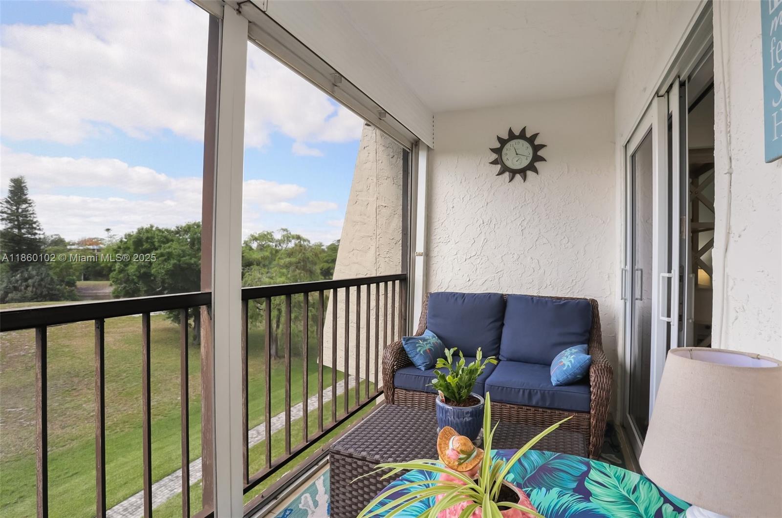 6020 Northwest 44th Street, Unit 401 Lauderhill, FL 33319 - Photo 12 of 35 a balcony view with a potted plant