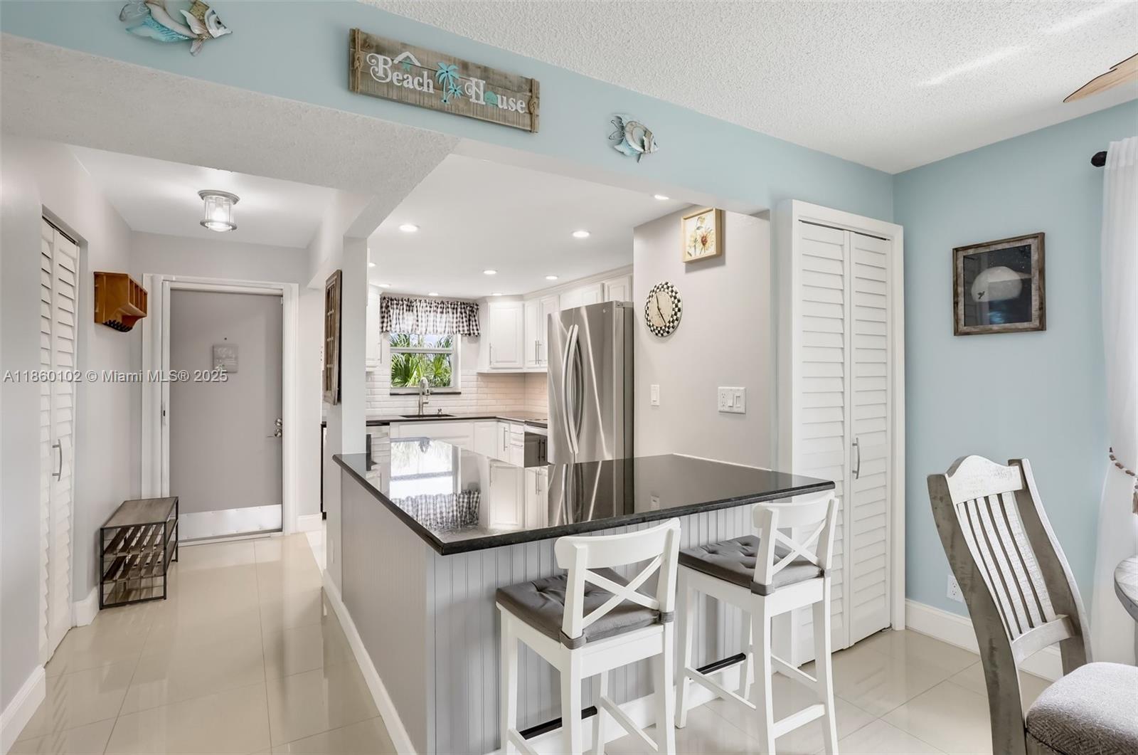 6020 Northwest 44th Street, Unit 401 Lauderhill, FL 33319 - Photo 15 of 35 a kitchen with stainless steel appliances granite countertop a refrigerator and a sink