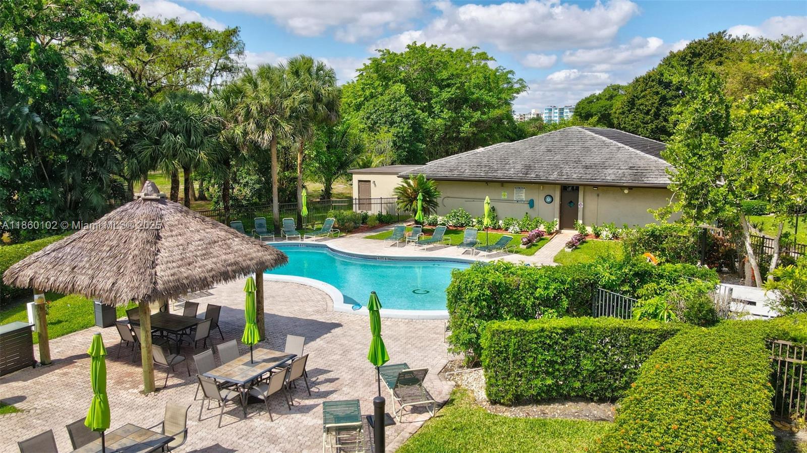 6020 Northwest 44th Street, Unit 401 Lauderhill, FL 33319 - Photo 2 of 35 a front view of a house with garden and plants