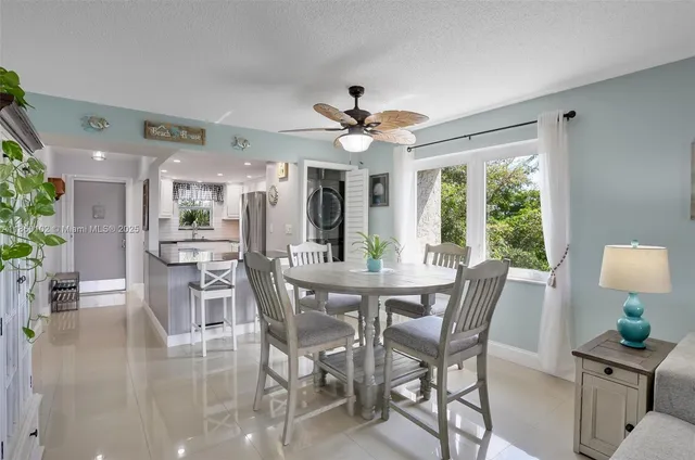 a bedroom with a large bed and a flat tv screen on dresser