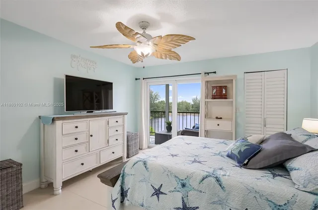 a spacious bathroom with a granite countertop sink a toilet a mirror and shower