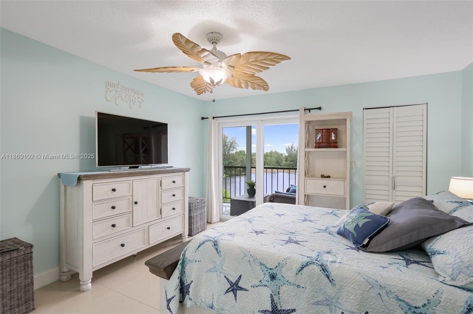 6020 Northwest 44th Street, Unit 401 Lauderhill, FL 33319 - Photo 23 of 35 a bedroom with a large bed and a flat tv screen on dresser