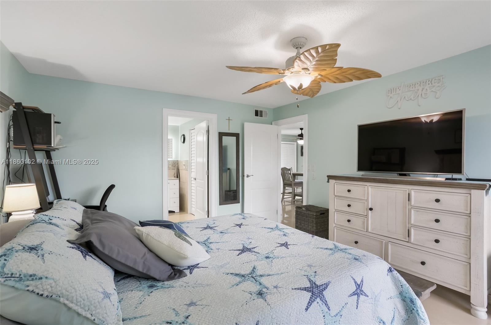 6020 Northwest 44th Street, Unit 401 Lauderhill, FL 33319 - Photo 24 of 35 a bedroom with a bed a flat screen tv and a fish tank on dresser