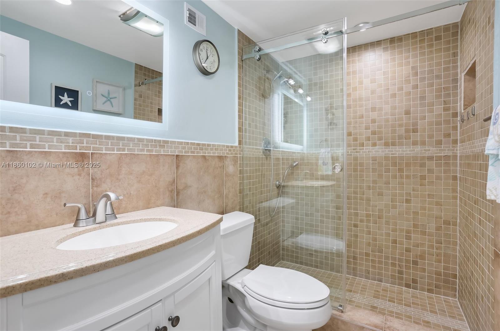 6020 Northwest 44th Street, Unit 401 Lauderhill, FL 33319 - Photo 27 of 35 a bathroom with a sink a toilet and shower