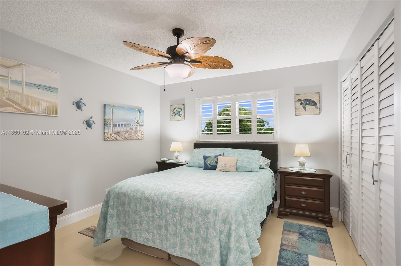 6020 Northwest 44th Street, Unit 401 Lauderhill, FL 33319 - Photo 28 of 35 a bedroom with a bed and a chandelier