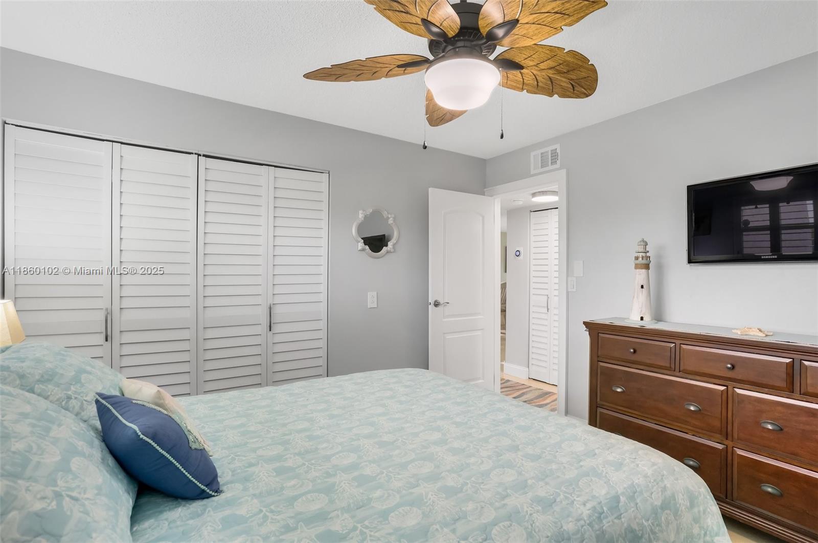 6020 Northwest 44th Street, Unit 401 Lauderhill, FL 33319 - Photo 29 of 35 a bedroom with a bed and a flat screen tv