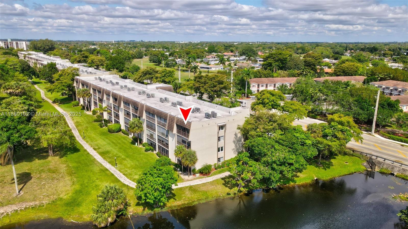 6020 Northwest 44th Street, Unit 401 Lauderhill, FL 33319 - Photo 32 of 35 a view of a swimming pool with lawn chairs and plants