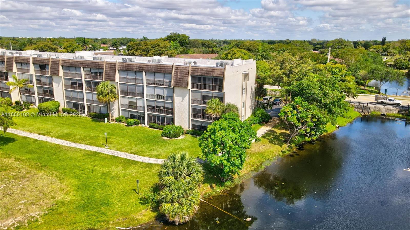 6020 Northwest 44th Street, Unit 401 Lauderhill, FL 33319 - Photo 33 of 35 a view of a garden with a building in the background