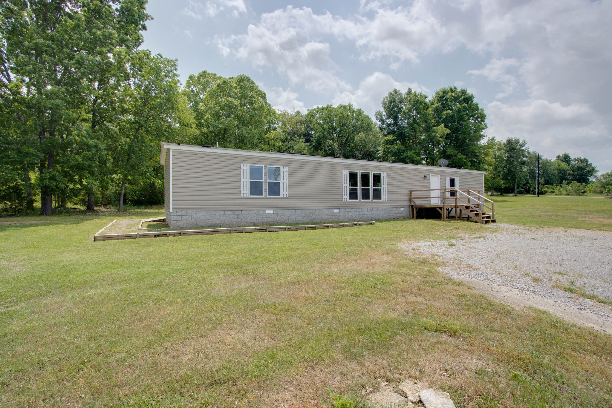 591 Alsup Road Lascassas, TN 37085 - Photo 6 of 32 a view of a house with backyard and trees