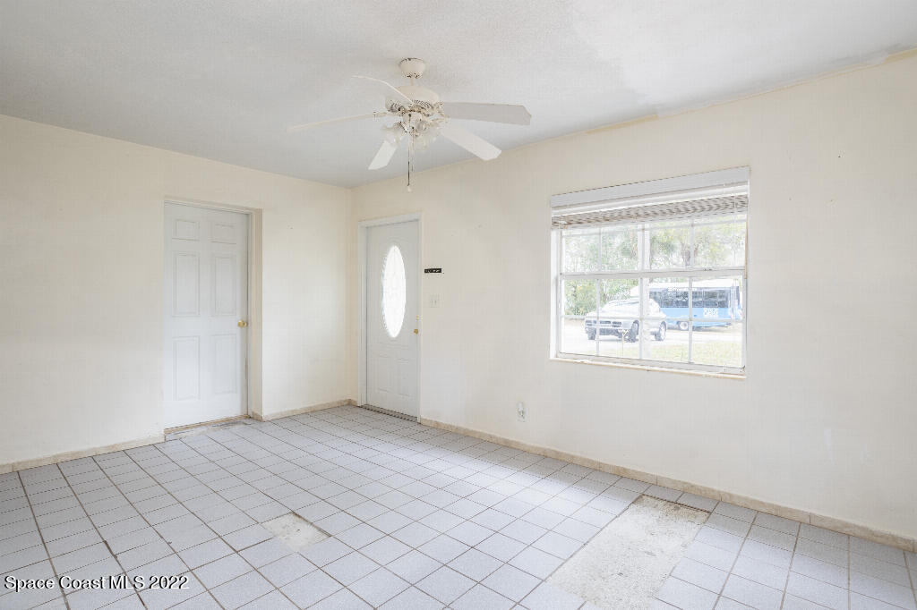 734 Bonnie Circle Melbourne, FL 32901 - Photo 4 of 15 an empty room with windows and fan