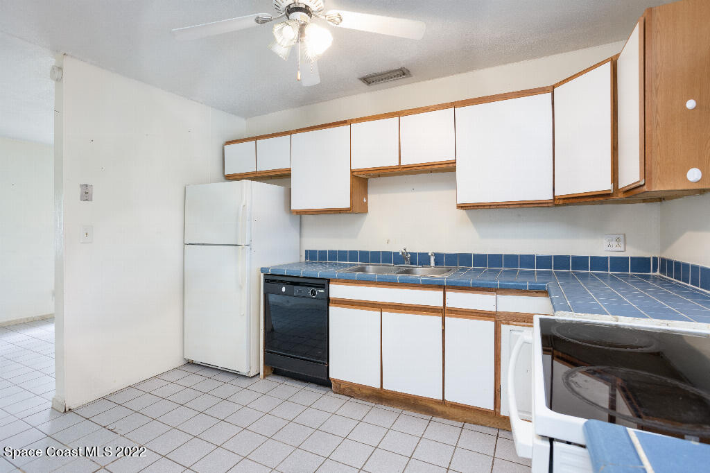 734 Bonnie Circle Melbourne, FL 32901 - Photo 7 of 15 a kitchen with stainless steel appliances granite countertop a refrigerator sink and cabinets
