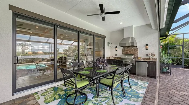 a bedroom with a bed television on desk and a window