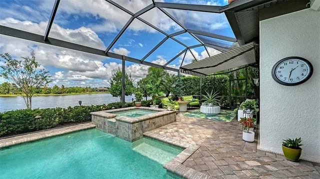 a view of a house with backyard water fountain and sitting area