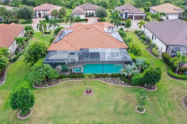 an aerial view of a house with a lake view
