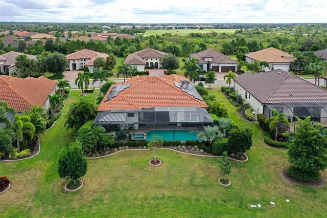an aerial view of a house with a lake view