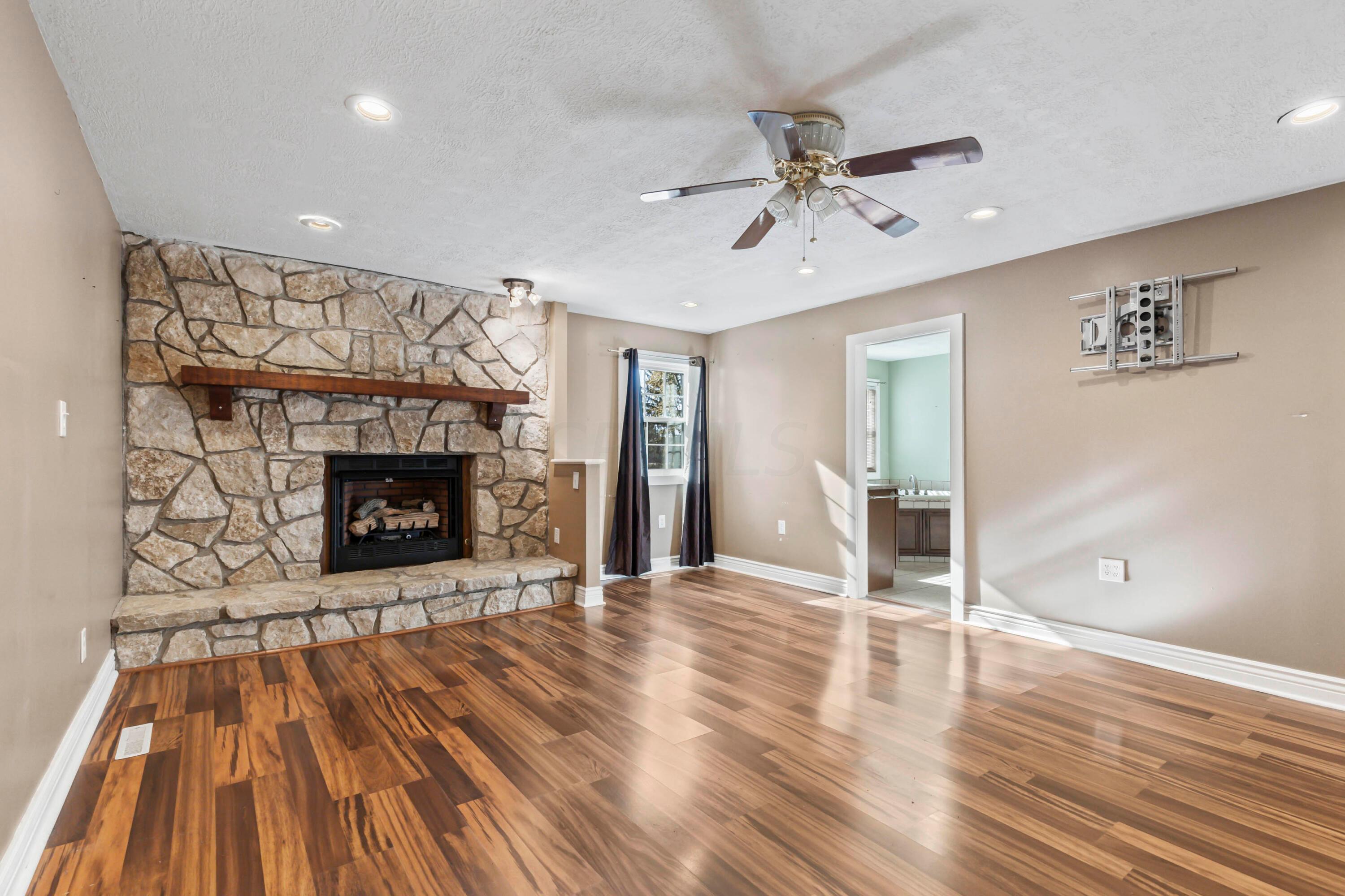 9495 Kilbourne Road Sunbury, OH 43074 - Photo 23 of 84 • Completely updated ~2007
• New tigerwood flooring
~03/2013
• Tan painted walls
• Stone fireplace with mantle &
raised hearth (gas insert
installed ~03/2013)
• (2) wall closets
• New front window ~ 2021
• Linen cabinet
• Lighted ceiling fan
• Can lighting
• Access to Dining Room
