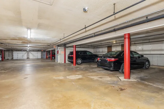 a view of parking garage with cars