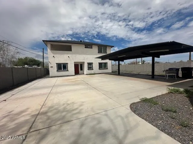 a kitchen with stainless steel appliances granite countertop a stove top oven a sink dishwasher and a refrigerator with wooden cabinets