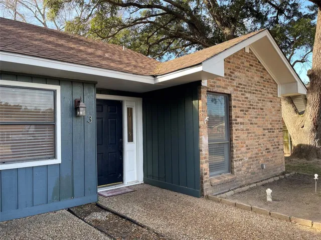 a view of a house with a door and wooden walls