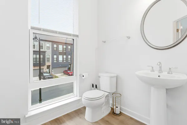 a bathroom with a toilet a sink and a mirror