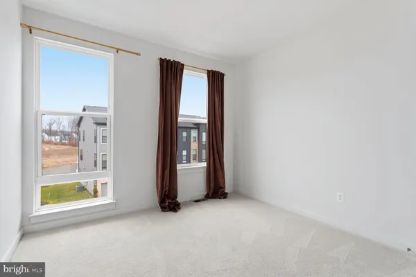 an empty room with windows and entrance