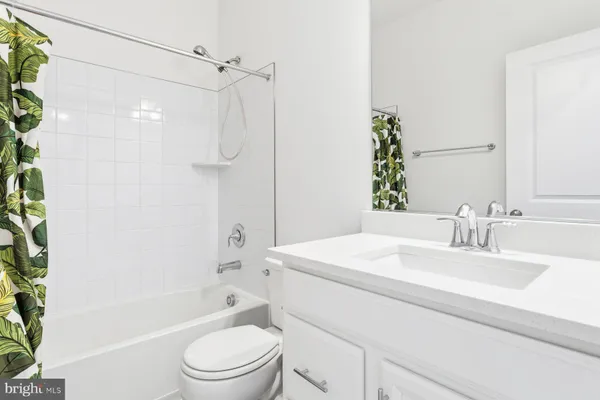 a bathroom with a sink a toilet a mirror a vanity and shower