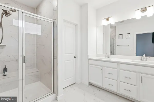 a bathroom with a double vanity sink and mirror