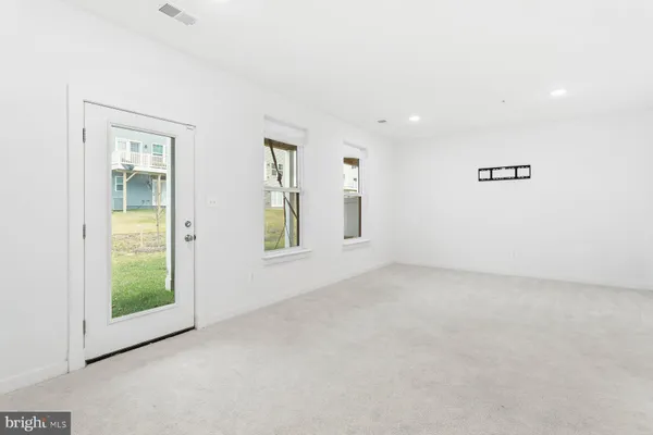 an empty room with windows and closet