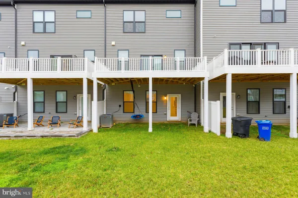 a view of a building with a yard chair and a table and chairs in patio
