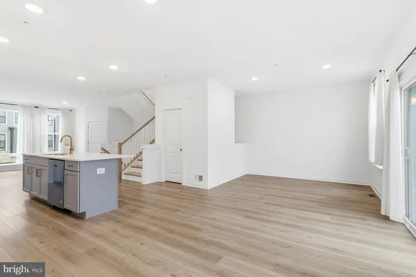 a view of kitchen with sink and wooden floor
